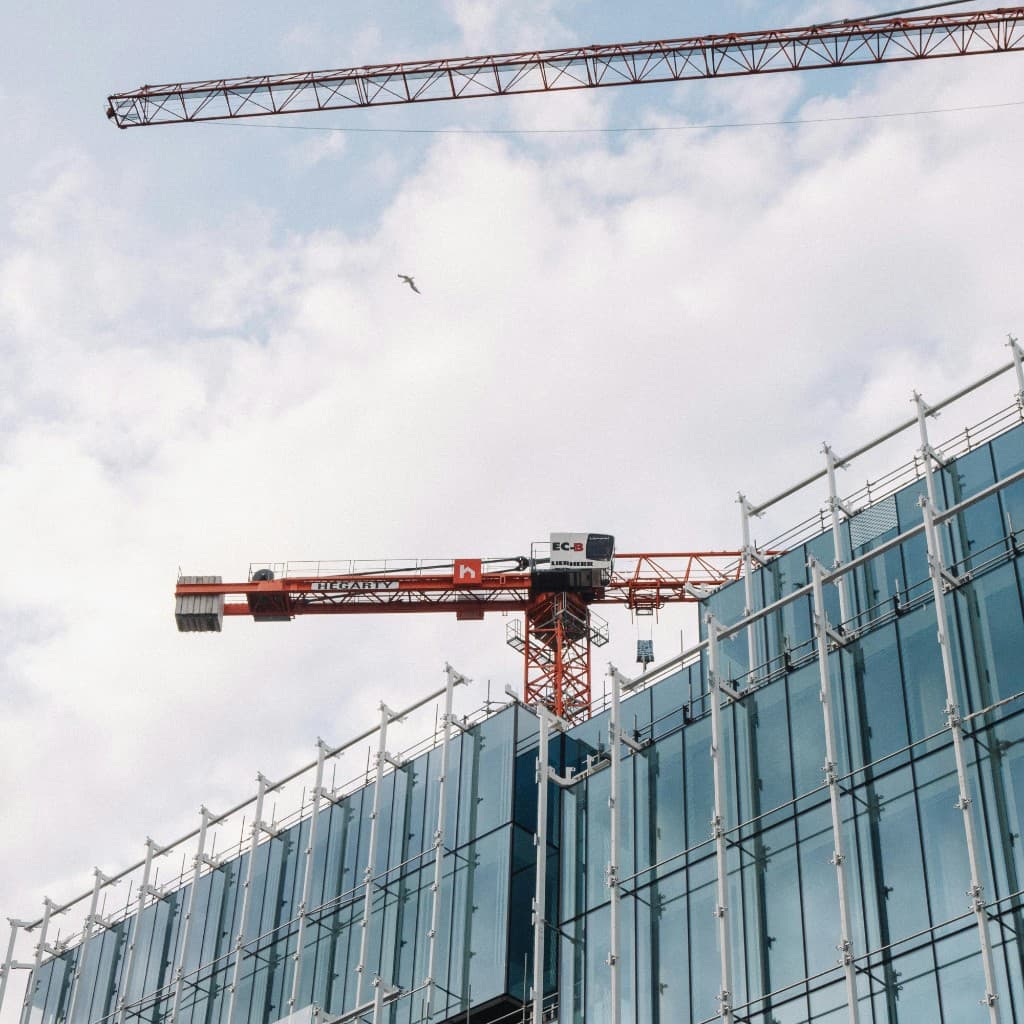 Commercial building under construction with tower crane